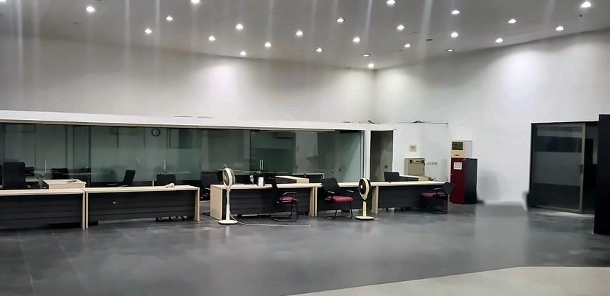Existing consultation desks and glazed office cabins in the fitted Kalma Motors showroom